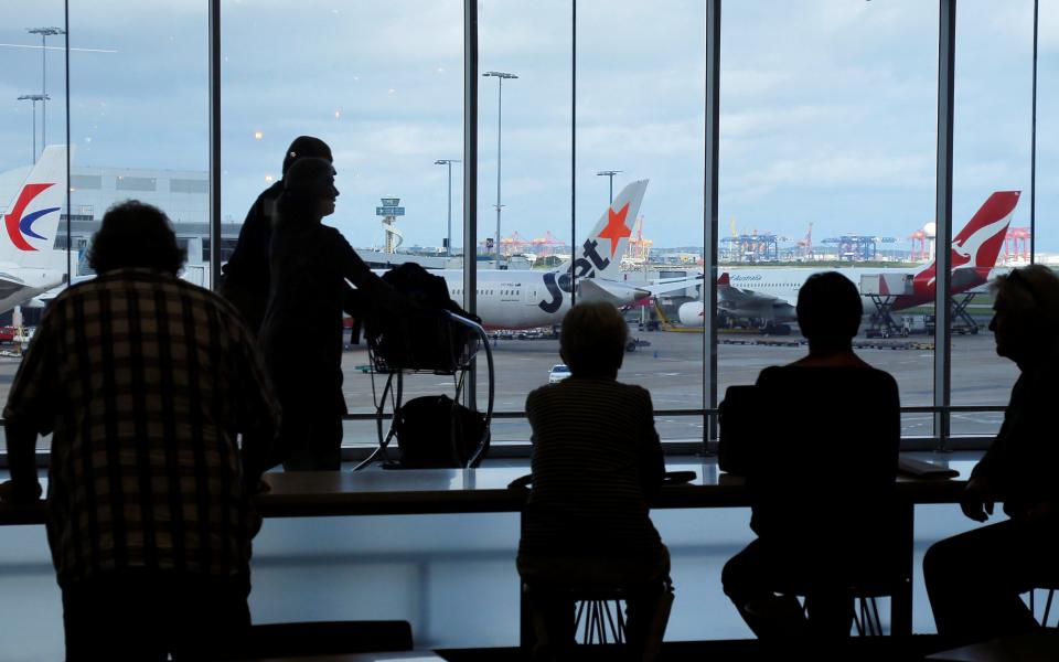 Passengers wait to board their flights at the Sydney International Airport - Credit: Reuters