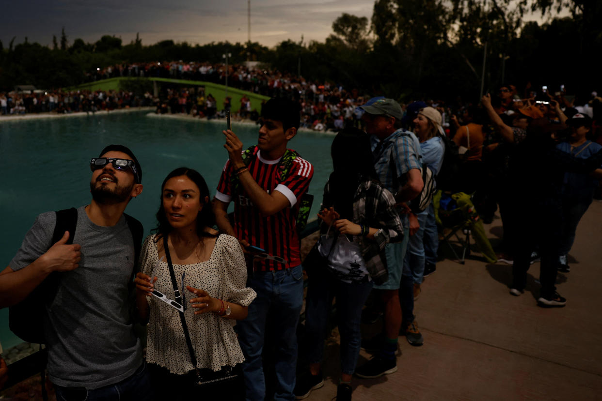 People observe the solar eclipse, in Torreon, Mexico. (Daniel Becerril/Reuters)
