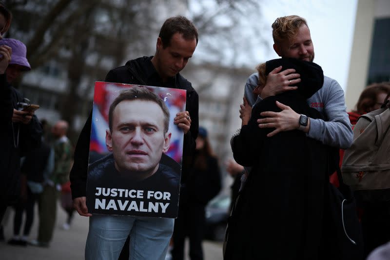 People attend a vigil after the death of Alexei Navalny, near the Russian embassy in Lisbon