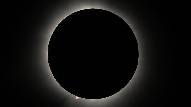 The April 8 total solar eclipse, showing a pronounced prominence at bottom. To observers on the ground, the prominences appeared as red dots along the perimeter of the eclipse. - Image: paramsach (<a class="link " href="https://www.flickr.com/photos/paramsach/" rel="nofollow noopener" target="_blank" data-ylk="slk:Fair Use;elm:context_link;itc:0;sec:content-canvas">Fair Use</a>)