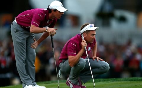 Rory McIlroy and Ian Poulter of Europe line up a putt on the 18th green during day two of the Afternoon Four-Ball Matches for The 39th Ryder Cup at Medinah Country Club - Credit: Getty images