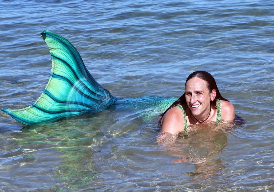 Mermaid Lavinia swims in the Atlantic Ocean at Wells Beach after sunning herself on the jetty Aug. 23, 2023.