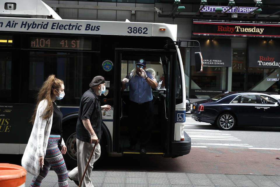 NEW YORK, NEW YORK - MAY 22:  A bus driver instructs passengers wearing protective masks during the coronavirus pandemic on May 22, 2020 in New York City. COVID-19 has spread to most countries around the world, claiming over 339,000 lives and infecting over 5.2 million people  (Photo by John Lamparski/Getty Images)