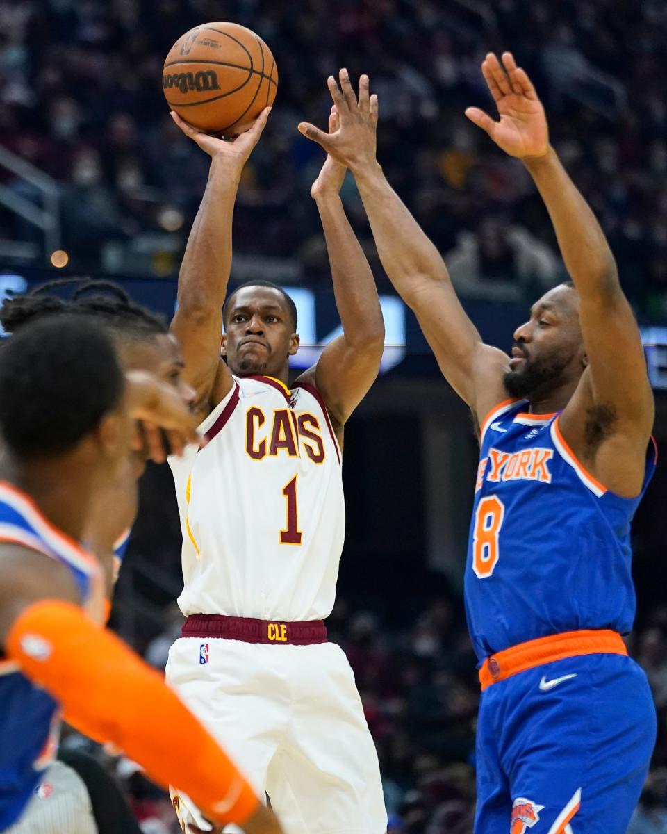 Cleveland Cavaliers' Rajon Rondo (1) shoots against New York Knicks' Kemba Walker (8) in the first half of an NBA basketball game, Monday, Jan. 24, 2022, in Cleveland. (AP Photo/Tony Dejak)