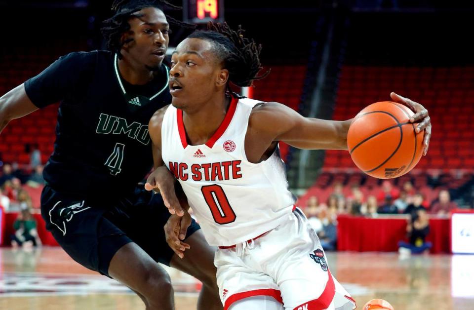 N.C. State’s DJ Horne (0) drives by Mount Olive’s Josiah Watkins (4) during the first half of N.C. State’s exhibition game against Mount Olive at PNC Arena in Raleigh, N.C., Wednesday, Nov. 1, 2023.