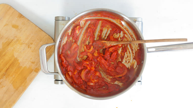 vodka, tomato paste and onions in a pan