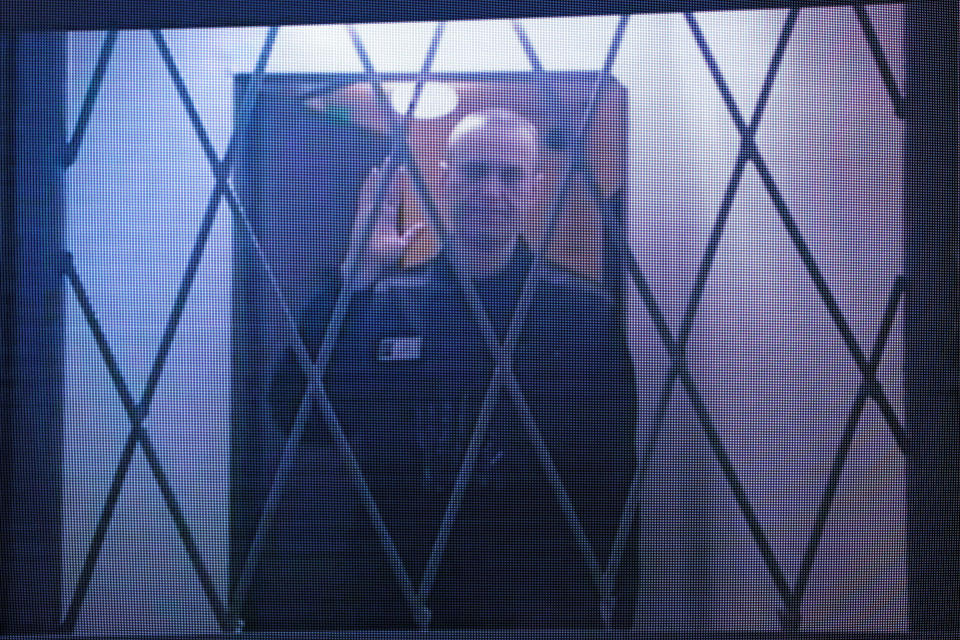 TOPSHOT - Jailed Russian opposition figure Alexei Navalny is seen on a screen via a video link from the IK-3 penal colony above the Arctic circle during a hearing of his complaint on restrictions placed on which books and reading material he can access in prison, at the Supreme Court in Moscow on January 11, 2024. (Photo by Vera Savina / AFP) (Photo by VERA SAVINA/AFP via Getty Images)