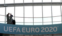 People look from a balcony with UEFA Euro 2020 soccer championship branding at the Convention Centre, Dublin, Sunday December 2, 2018, ahead of the UEFA Euro 2020 qualifying draw, at the Convention Centre in Dublin, Ireland, Sunday, Dec. 2, 2018. (Brian Lawless/PA via AP)