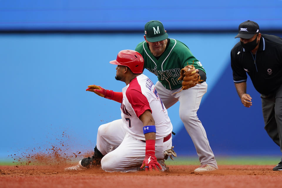 Dominican Republic's Charlie Valerio, left, slides into second base past Mexico's Daniel Espinosa for a double during a baseball game at Yokohama Baseball Stadium during the 2020 Summer Olympics, Friday, July 30, 2021, in Yokohama, Japan. (AP Photo/Matt Slocum)