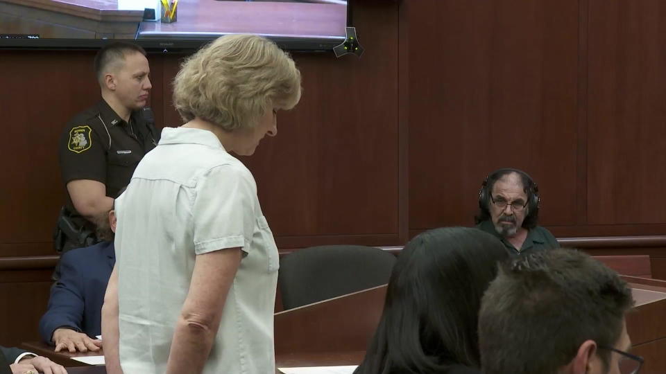 Janet Wood addresses Patrick Gilham at his sentencing.  Gilham, wearing headsets, appeared confused, as though he'd seen a ghost, when looking at Janet. / Credit: CBS News
