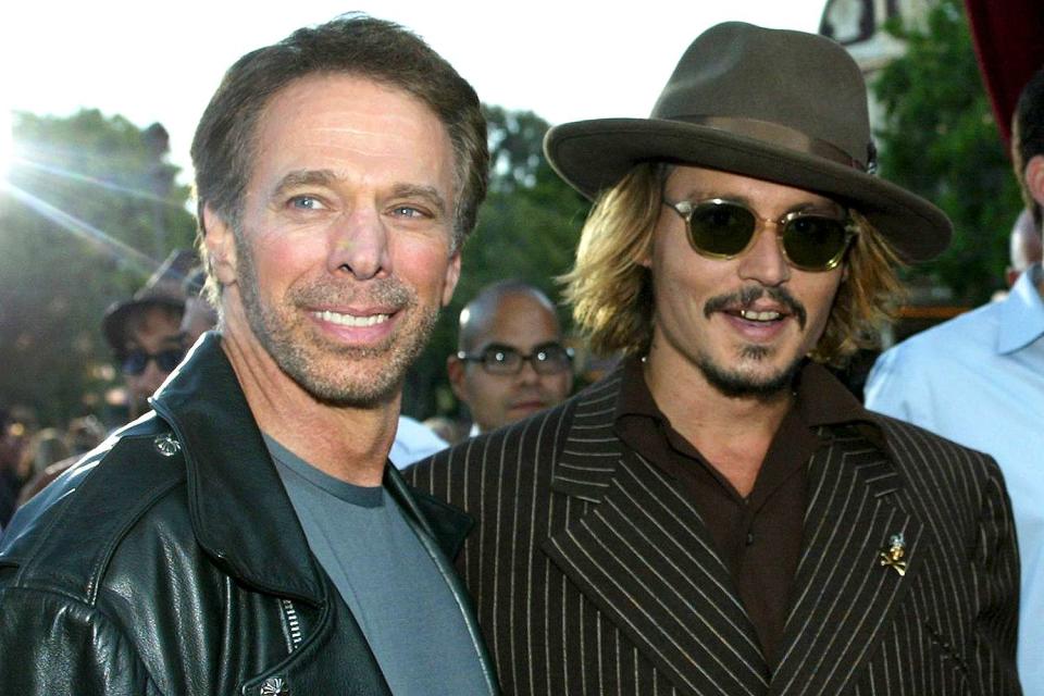 Director Jerry Bruckheimer and actor Johnny Depp attend the film premiere of "Pirates of the Caribbean" at Disneyland on June 28, 2003 in Anaheim, California.