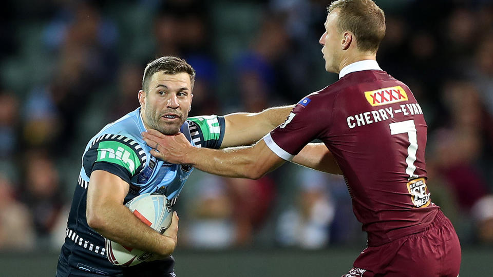 James Tedesco is pictured fending off Daly Cherry-Evans during the first game of the 2020 State of Origin series.