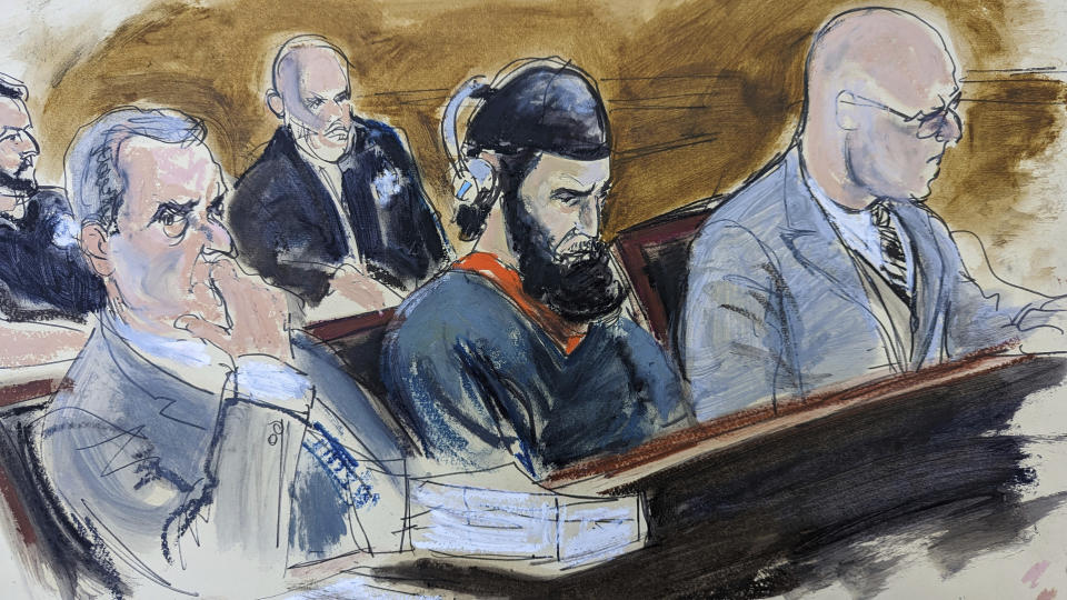 In this courtroom sketch, in federal court in New York, Wednesday, May 17, 2023, Sayfullo Saipov, center, is flanked by his attorneys, David M. Stern, left, and federal Defender Andrew John Dalack, right, during victim impact statements in the sentencing phase of his trial. Saipov, an Islamic extremist who killed eight in a New York bike path attack, was convicted of federal crimes, Jan. 26 2023. (AP Photo/Elizabeth Williams)