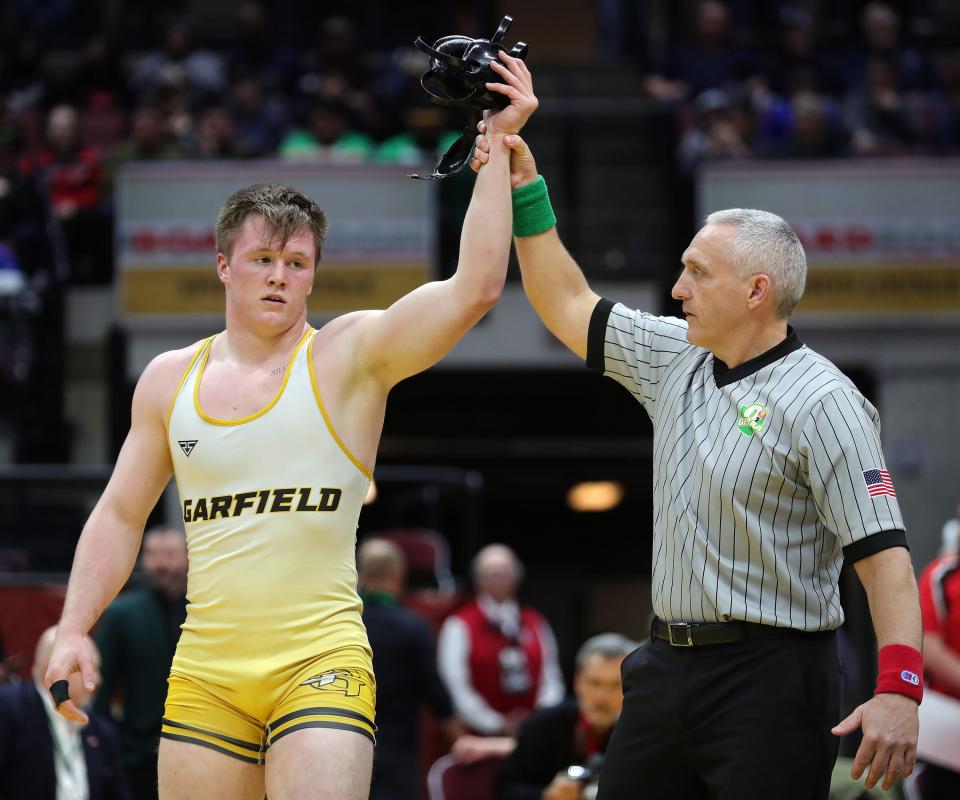 Keegan Sell of Garrettsville Garfield has his arm raised after winning the 190-pound Division III championship match in the OHSAA State Wrestling Tournament at the Jerome Schottenstein Center, Sunday, March 12, 2023, in Columbus, Ohio.