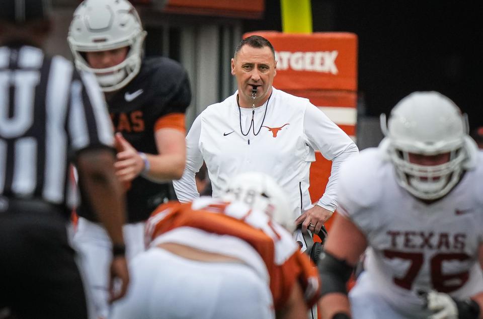 Texas head coach Steve Sarkisian watches Saturday's Orange-White spring game from behind the play during the first quarter at Royal-Memorial Stadium.