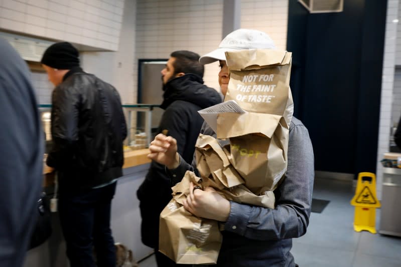 A worker carries takeout orders for pickup at the at a Chopt Creative Salad Co., location in New York