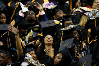 <p>Graduates look at the screen during a commencement for Medgar Evers College in the Brooklyn borough of New York City, New York, U.S., June 8, 2017. (Photo: Carlo Allegri/Reuters) </p>