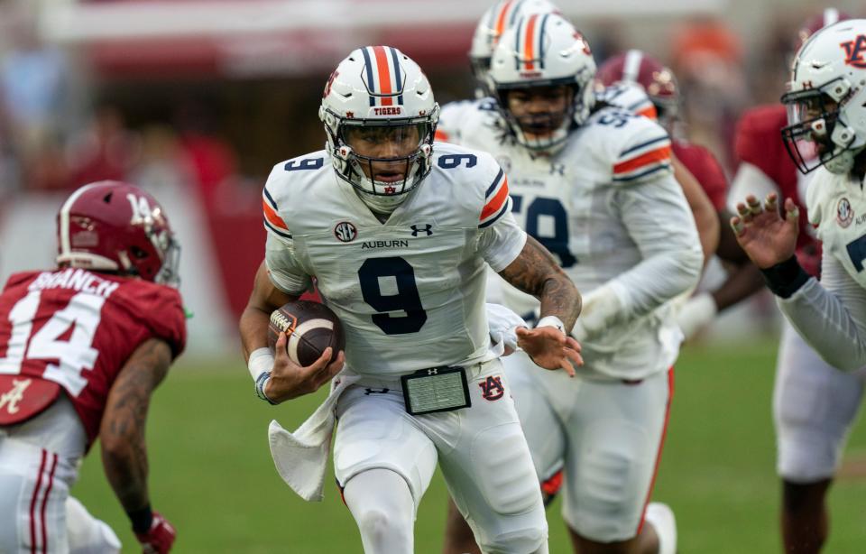 Nov 26, 2022; Tuscaloosa, Alabama, USA; Auburn Tigers quarterback Robby Ashford (9) carries the ball against the Alabama Crimson Tide  at Bryant-Denny Stadium. Mandatory Credit: Marvin Gentry-USA TODAY Sports