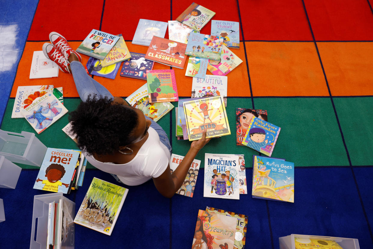 Kindergarten teacher Princess Bryant cleans up and prepares her classroom, from where she will begin the new school year teaching classes virtually, at the Tynan Elementary School in Boston, September 18, 2020. (REUTERS/Brian Snyder)