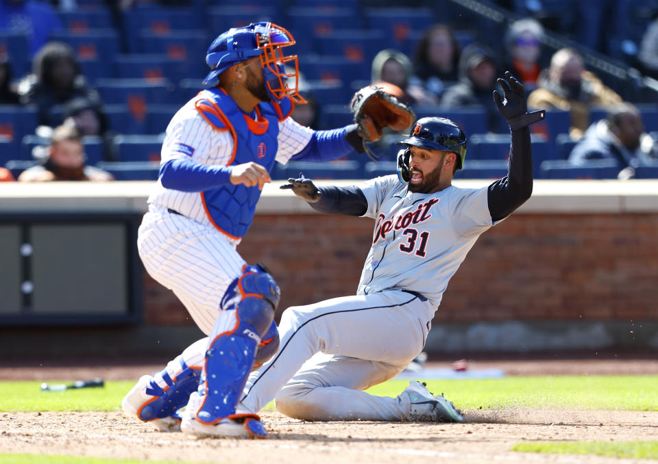Detroit Tigers' Riley Greene (31) scores past New York Mets catcher Francisco Alvarez (4) during the 11th inning in the first baseball game of a doubleheader, Thursday, April 4, 2024, in New York. (AP Photo/Noah K. Murray)