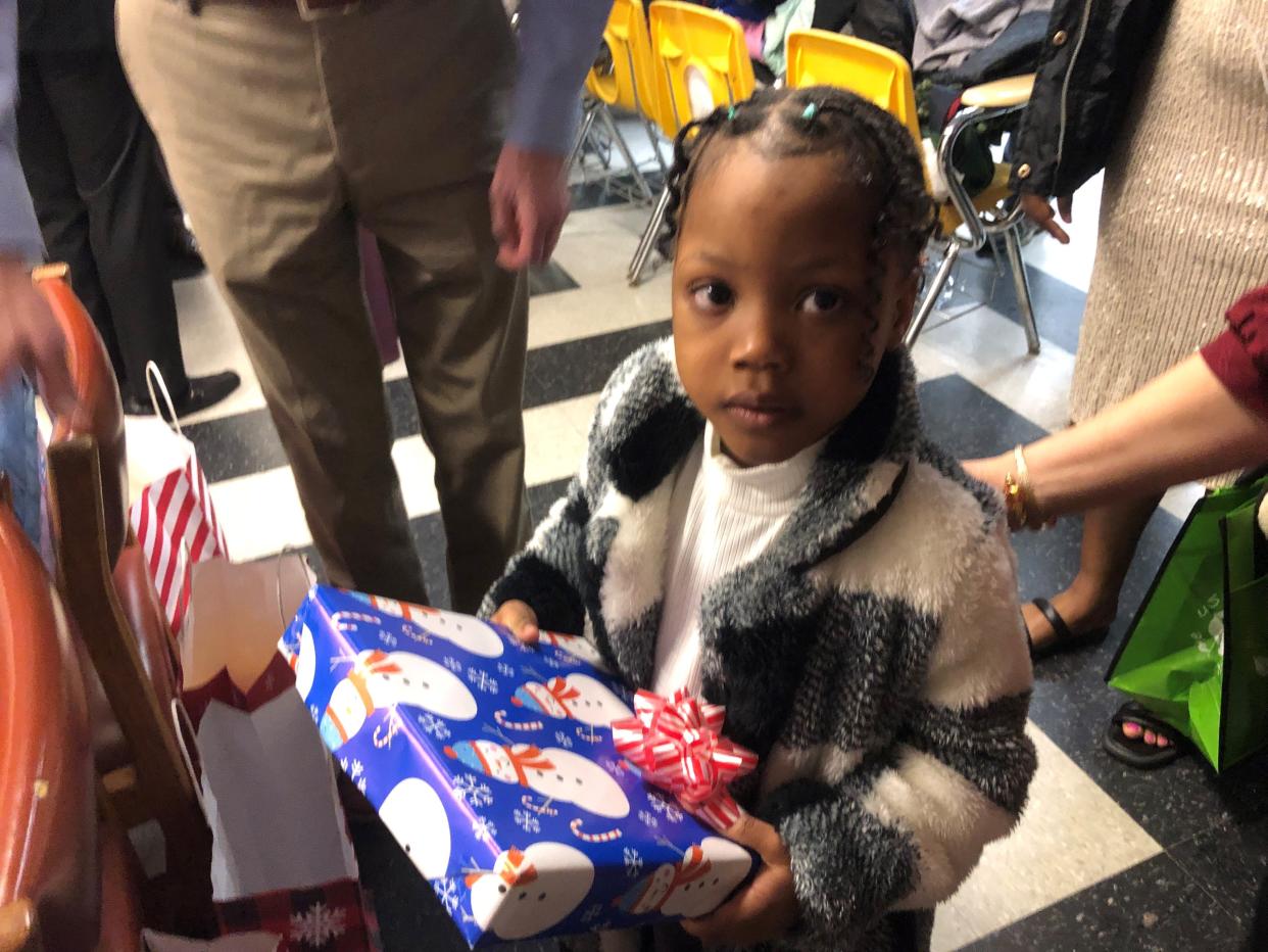 Thea Joseph, 5, picks out a toy during a coat and toy distribution Sunday, Dec. 17, 2023, at Konbit Neg Lakay in Spring Valley.