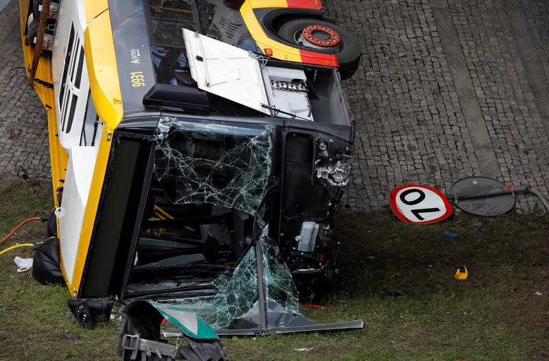 Crashed city bus is seen after falling off a motorway bridge in Warsaw