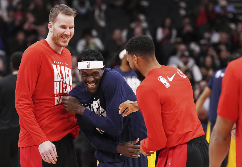 Indiana Pacers' Pascal Siakam, center, greets former Toronto Raptors teammates Jakob Poeltl, left, and Garrett Temple before an NBA basketball game Wednesday, Feb. 14, 2024, in Toronto. (Chris Young/The Canadian Press via AP)