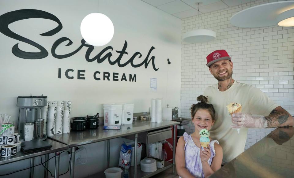 Ryan Povlick and his daughter Gianna stand behind the counter at Scratch Ice Cream in Brookfield on May 23, 2023. "I want to be a business owner when I grow up," Gianna said.