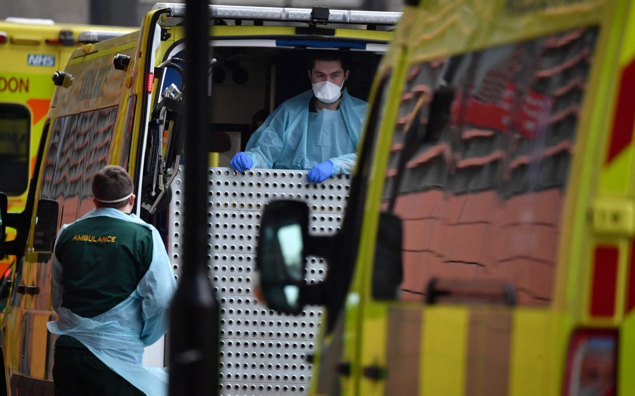 Paramedics in full PPE prepare an ambulance outside the Royal London Hospital in east London - BEN STANSALL / AFP