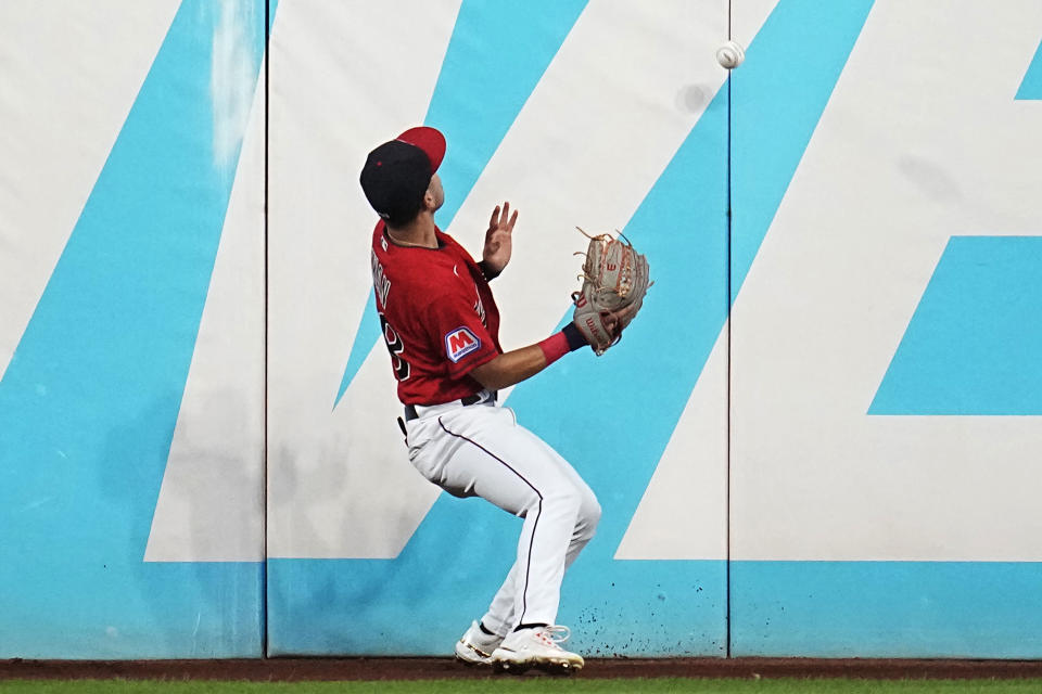 Cleveland Guardians left fielder Steven Kwan watches a ball hit for a double by Minnesota Twins' Kyle Farmer bounce off the outfield wall in the sixth inning of a baseball game Tuesday, Sept. 5, 2023, in Cleveland. (AP Photo/Sue Ogrocki)