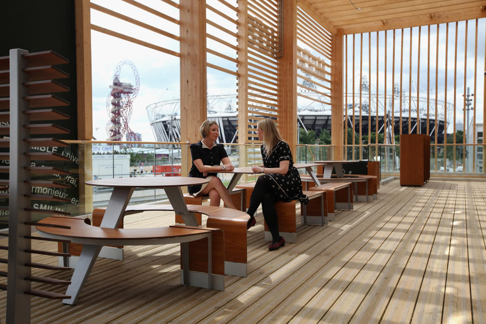 LONDON, ENGLAND - JUNE 25: Two women chat on the balcony of the world's largest McDonald's restaurant which is their flagship outlet in the Olympic Park on June 25, 2012 in London, England. The restaurant, which is one of four McDonald's to be situated within the Olympic Park, will have a staff of 500. After the Olympic and Paralympic Games conclude the restaurant will be dismantled and all fixtures and fittings will be either reused or recycled. (Photo by Oli Scarff/Getty Images)