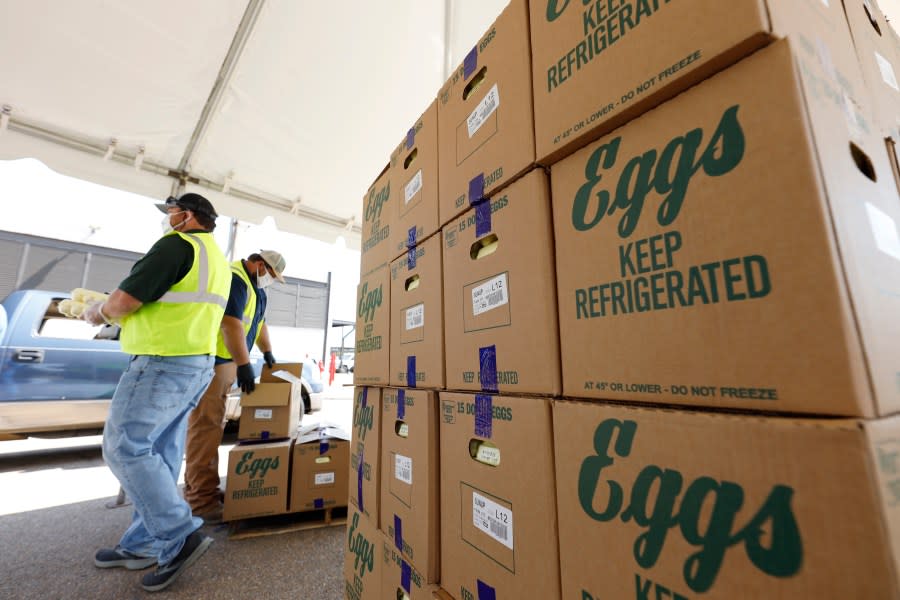 Cases of eggs from Cal-Maine Foods, Inc., await to be handed out by the Mississippi Department of Agriculture and Commerce employees at the Mississippi State Fairgrounds in Jackson, Miss., on Aug. 7, 2020. (AP Photo/Rogelio V. Solis, file)