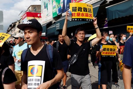 Anti-parallel trading protesters shout slogans during a march at Sheung Shui, a border town in Hong Kong