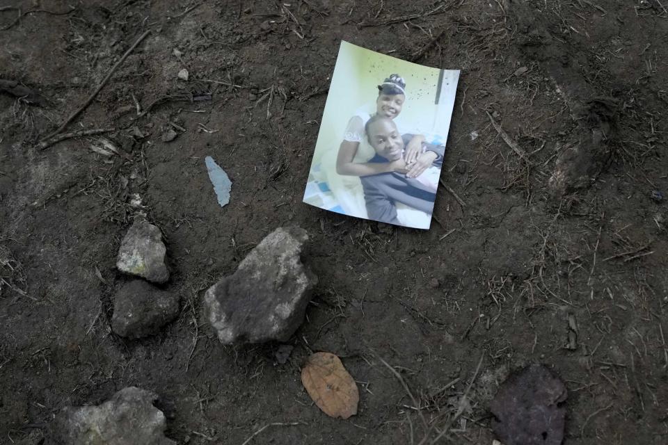 A family snapshot lays on the ground near a trail used by migrants, near Acandi, Colombia, Wednesday, Sept. 15, 2021. The migrants, mostly Haitians, are on their way to crossing the Darien Gap from Colombia into Panama dreaming of reaching the U.S. (AP Photo/Fernando Vergara)