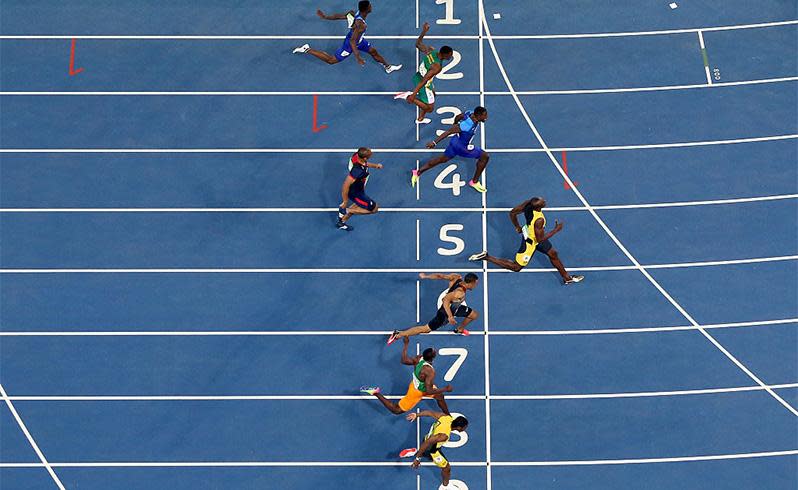 Usain Bolt over took Justin Gatlin in the final 50 metres to take out his third gold medal in the event. Photo: Getty