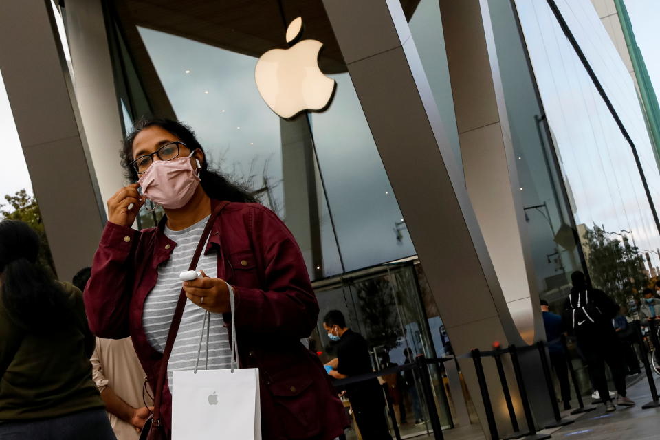 A customer exits after picking up Apple's new 5G iPhone 12 that went on sale, as the coronavirus disease (COVID-19) outbreak continues, at an Apple Store in Brooklyn, New York, U.S. October 23, 2020. REUTERS/Brendan McDermid