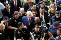 <p>Former Malaysian prime minister Najib Razak being escorted into the Kuala Lumpur Courts Complex on Wednesday (4 July) morning. (PHOTO: Reuters) </p>