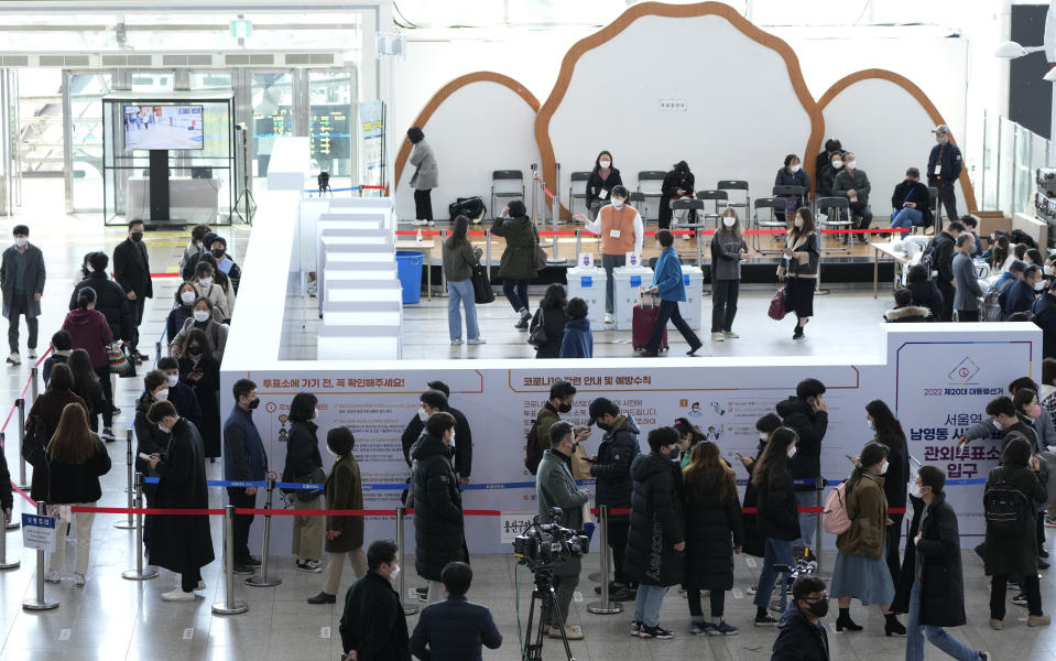 FILE - People wait in line to cast their early votes for the March 9 presidential election at a local polling station in Seoul, South Korea, March 5, 2022. Members of South Korea’s ruling conservative party have proposed a bill that would place tighter restrictions on the voting rights of foreign permanent residents in local elections, which they insist is necessary to protect the country’s democracy from being undermined by Chinese voters. (AP Photo/Ahn Young-joon, File)