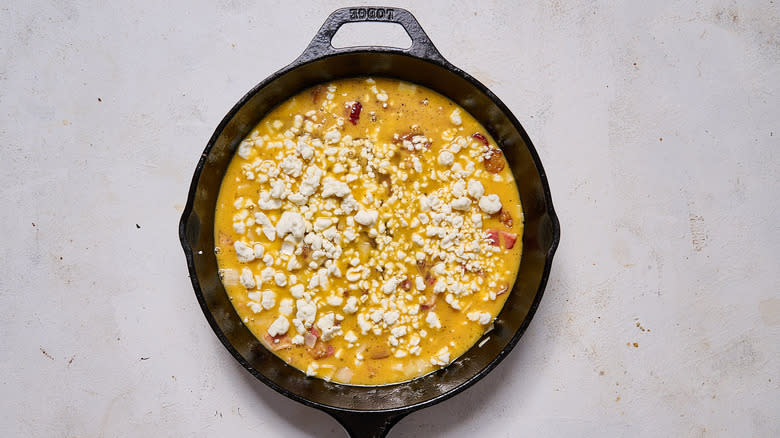 crumbled goat cheese in skillet