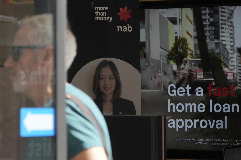 A man walks into a National Australia Bank branch in Sydney, Tuesday, March 7, 2023. Australia’s central bank increased its benchmark interest rate by another quarter-point to 3.6% Tuesday as it continues trying to tame inflation. (AP Photo/Rick Rycroft)