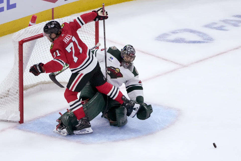 Minnesota Wild goaltender Marc-Andre Fleury makes a save against Chicago Blackhawks left wing Taylor Hall during the shootout in an NHL preseason hockey game Thursday, Oct. 5, 2023, in Chicago. The Wild won 3-2. (AP Photo/Charles Rex Arbogast)
