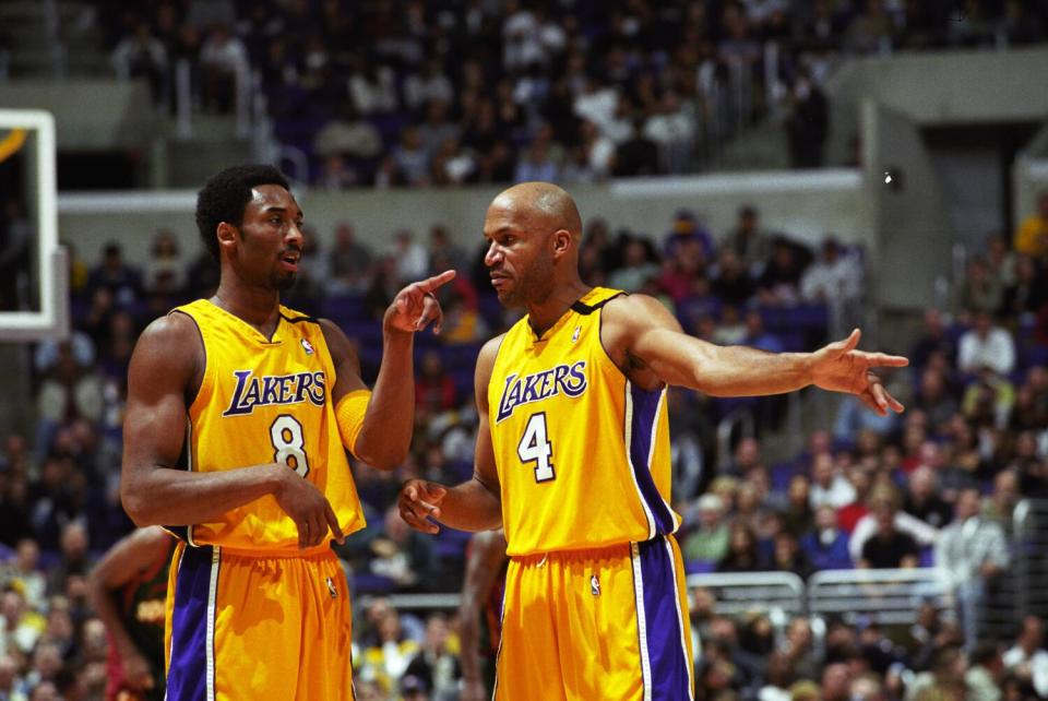 Lakers guards Kobe Bryant, left, and Ron Harper discuss strategy during a break in play.