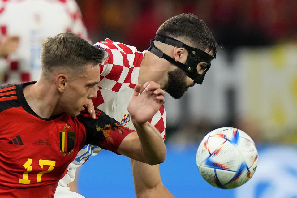 Belgium's Leandro Trossard, left, and Croatia's Josko Gvardiol fight for the ball during the World Cup group F soccer match between Croatia and Belgium at the Ahmad Bin Ali Stadium in Al Rayyan, Qatar, Thursday, Dec. 1, 2022. (AP Photo/Luca Bruno)