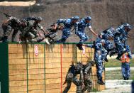 <p>Chinese marines compete during an obstacle course of the Seaborne Assault contest as part of the International Army Games 2018 on July 30, 2018 in Quanzhou, Fujian Province of China. (Photo: VCG via Getty Images) </p>