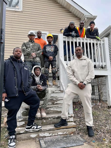 PHOTO: Faheem Muhammad and employees of the OASIS group stand in front of one of their houses in Chicago. (Courtesy of Faheem Muhammad)