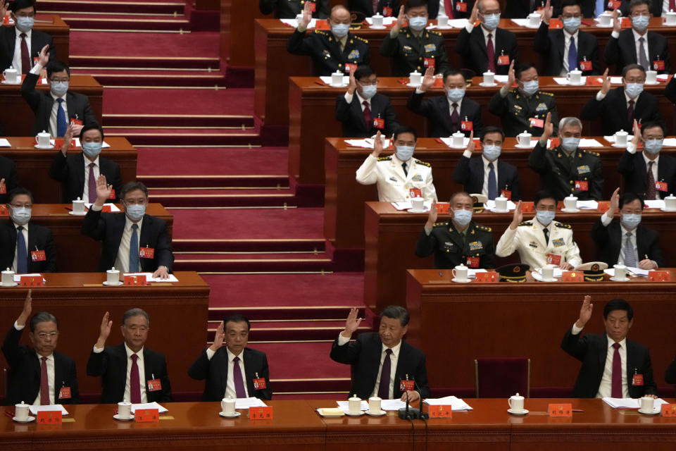 Chinese President Xi Jinping, bottom row center, and other delegates attend the closing ceremony of the 20th National Congress of China's ruling Communist Party at the Great Hall of the People in Beijing, Saturday, Oct. 22, 2022. (AP Photo/Ng Han Guan)