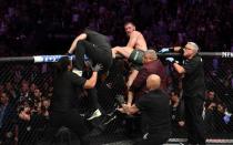 Conor McGregor tapped out in the fourth round of his comeback fight at UFC 229 against Khabib Nurmagomedov, who then climbed over the cage and set off a brawl by attempting to fight someone in McGregor's corner on Saturday night.