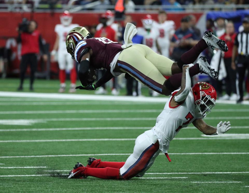 Michigan Panthers receiver Ishmael Hyman (13) is tackled by New Jersey Generals free safety Dravon Askew-Henry (7) during the first half Sunday, April 30, 2023 at Ford Field.