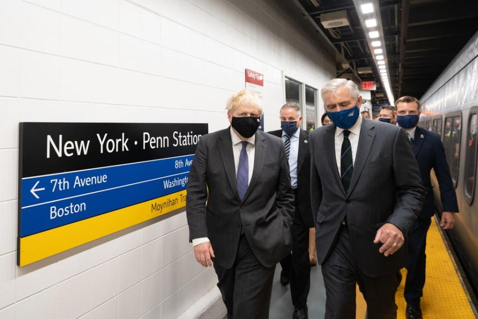 Boris Johnson (left), accompanied by Amtrak CEO William J Flynn, prepares to board a train from Penn Station in New York to Washington DC (Stefan Rousseau/PA) (PA Wire)