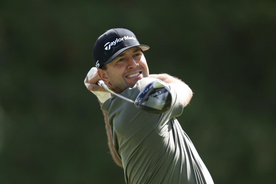 Taylor Montgomery hits off the fourth tee during the first round of the Rocket Mortgage Classic golf tournament at Detroit Country Club, Thursday, June 27, 2024, in Detroit. (AP Photo/Paul Sancya)